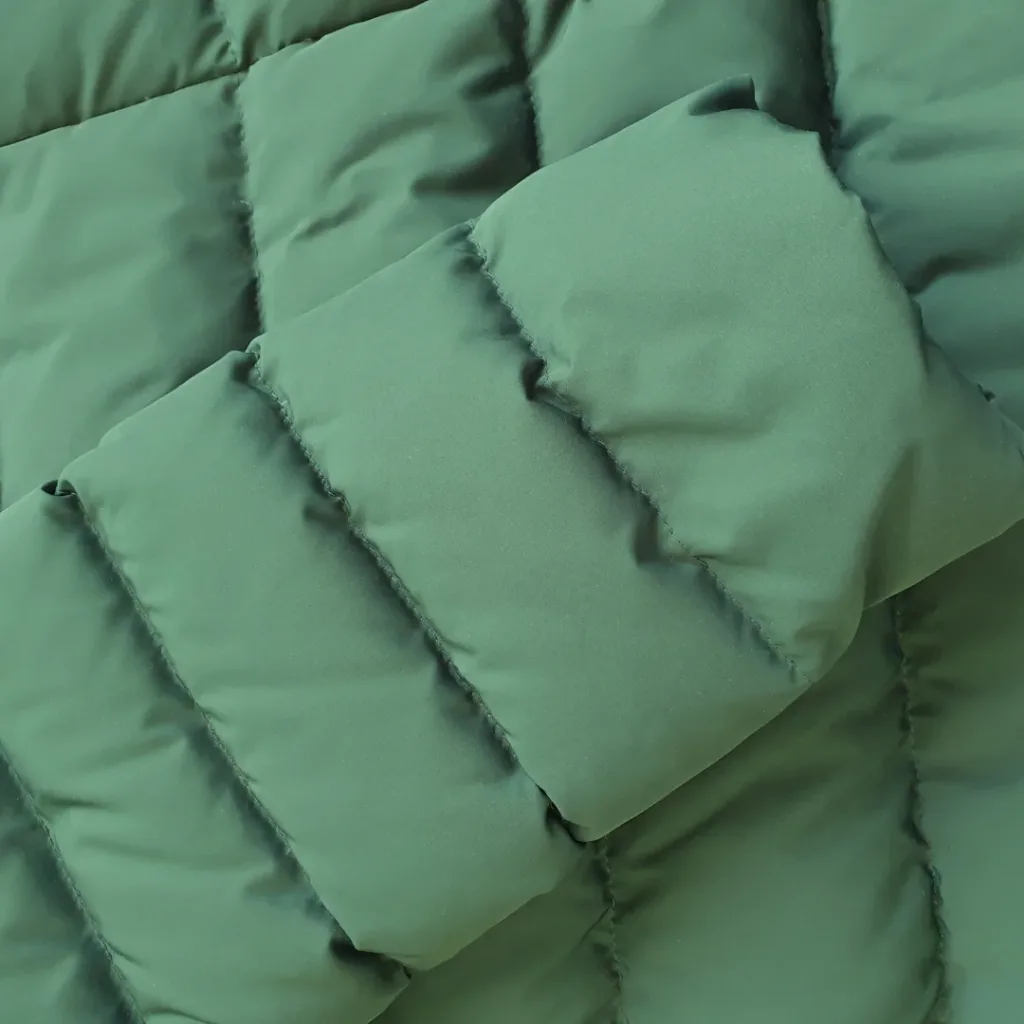 Snoopy's puffer jacket comes in a shade of green.